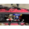 Image 1 : Husky tool bag with various tools, rope, ratchet, snips, spongy cords, trowels, and tools.