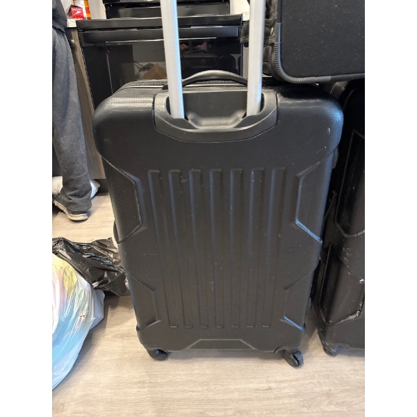 These are black Outbound hardside spinner suitcases, featuring a durable design and a built-in teles