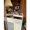Image 1 :  white dresser, full of books, Alberta ghost stories, Sudoku game, lots of figurines, and display sh