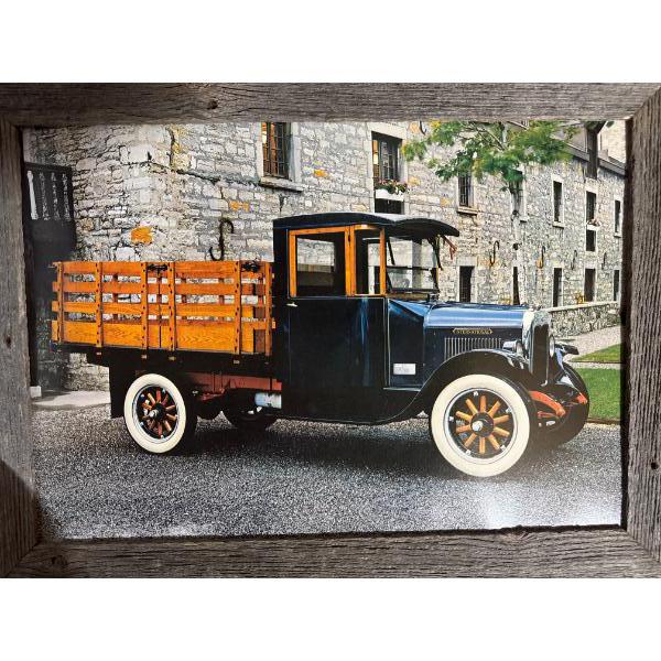  photograph of a vintage International truck, likely dating back to the late 1920s, featuring a wood