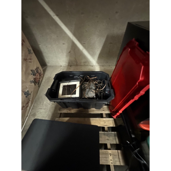 Tupperware container full of miscellaneous electronics, wiring for speakers, various items.