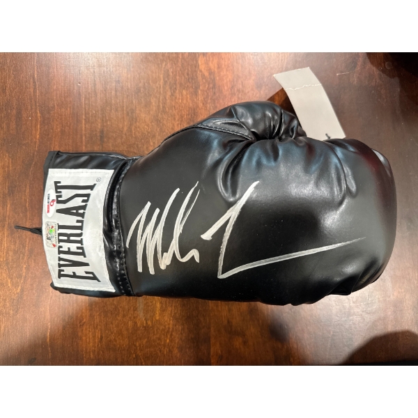  Mike Tyson autographed black Everlast boxing glove. 
Signed Item: A black Everlast boxing glove han