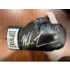Image 1 :  Mike Tyson autographed black Everlast boxing glove. 
Signed Item: A black Everlast boxing glove han