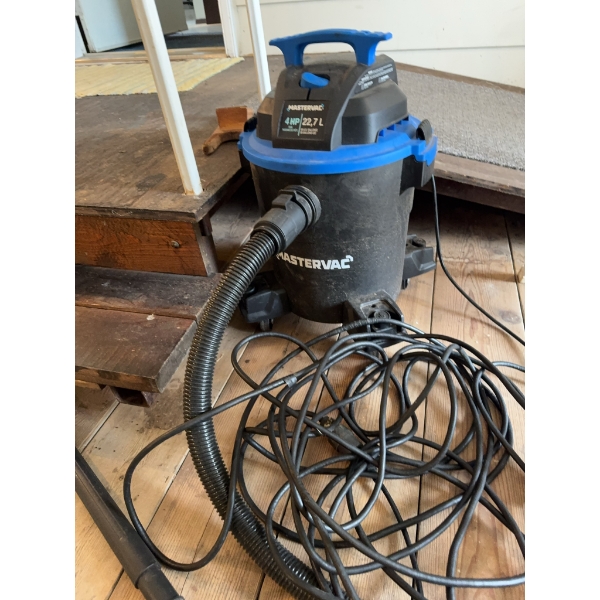 Mastervac wet/dry vacuum with 4 HP motor and 22.7 liter capacity. Features include a black body with