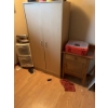 Image 4 : Wooden storage cabinet featuring double doors with metal handles. The interior includes shelving for
