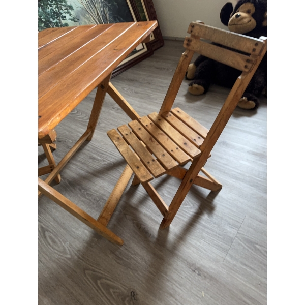 One rectangular folding table and two matching folding chairs. Made of wood with horizontal slat des