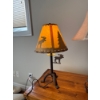 Image 1 : This is a rustic moose themed table lamp featuring a metal base and a faux leather or rawhide shade
