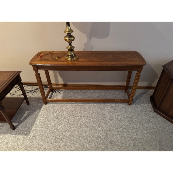 vintage-style wood console or sofa table featuring a patterned veneer top and four fluted legs. 