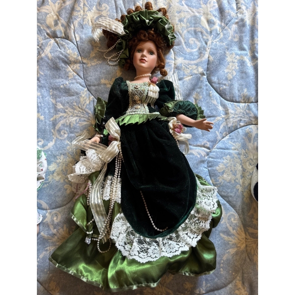  large 18 inch doll, and porcelain doll, smaller one beside it.