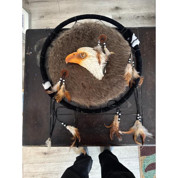  decorative dreamcatcher featuring a prominent eagle head design and fur-like texture, commonly used