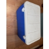 Image 1 : Coleman cooler featuring a blue plastic body and a white removable hinged lid, equipped with secure 