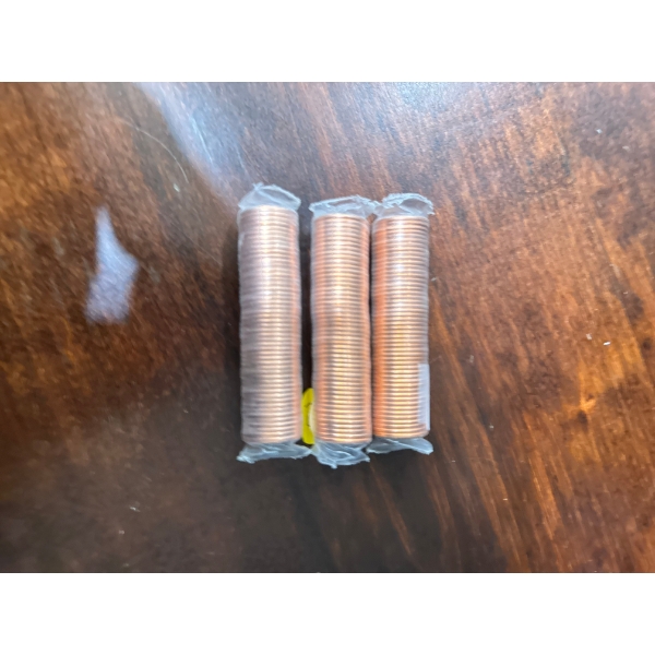 Canadian 1-cent coins, commonly known as pennies. 
These rolls typically contain uncirculated coins