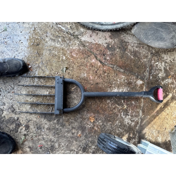 heavy-duty gardening fork, likely used for breaking up clods, loosening, lifting, and turning over s
