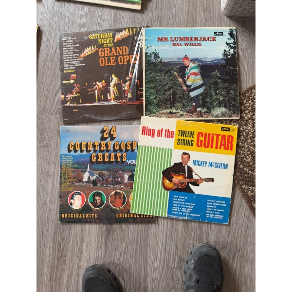 Four vinyl records: 'Saturday Night at the Grand Ole Opry', 'Mr. Lumberjack' by Hal Willis, '24 Coun