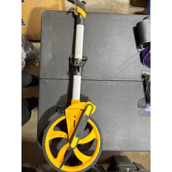 Measuring wheel. Measures in feet and inches with extension.