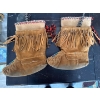 Image 3 : mukluks feature traditional fringe detailing, intricate beadwork on the vamp, and are lined for warm