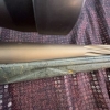 Image 22 : Ruger American bolt-action rifle chambered in 7mm-08 Rem. Features a green speckled synthetic stock,