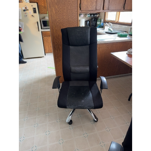 Multiple black office chairs featuring mesh and fabric upholstery, high backs, and armrests. The cha