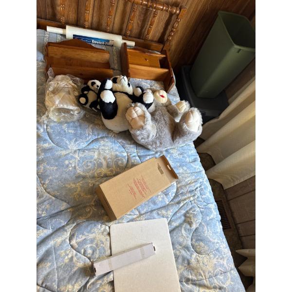  single wood bed frame with teddy bears and wall hanging wood attachments.