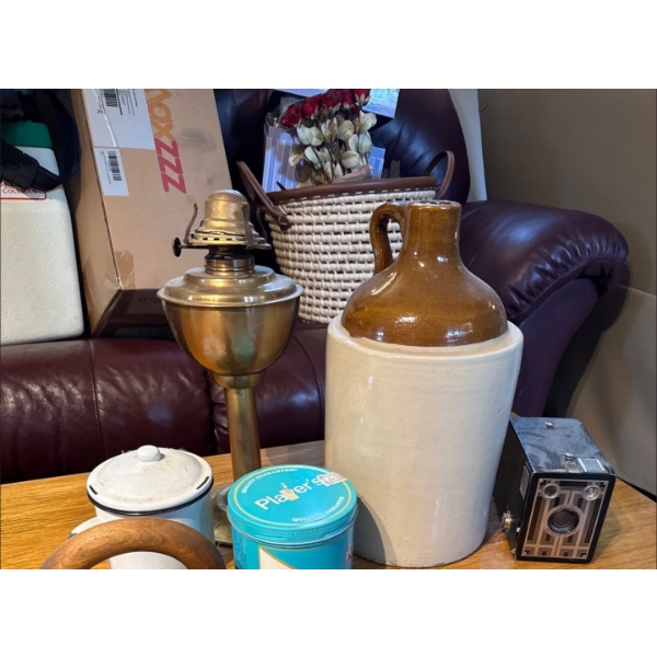 collection of antique items featuring a prominent two-toned stoneware jug, likely a whiskey or moon