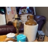 Image 1 :  collection of antique items featuring a prominent two-toned stoneware jug, likely a whiskey or moon