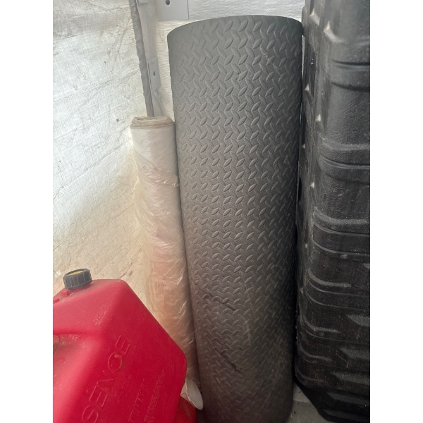 Rubber matting that is 46in wide and 72in long and a roll of plastic wrap