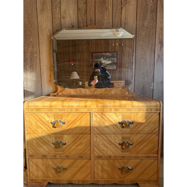 This is a vintage Art Deco "waterfall" dresser with a mirror, popular from the late 1920s to the 194