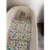 Image 4 : White wicker baby bassinet with folding legs, lace trim, fitted colorful smiley face fabric, and thr