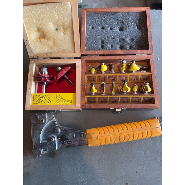 Two boxes of assorted router bits, with nine yellow-handled bits and two red-handled bits, along wit