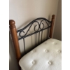 Image 2 :  twin-sized mattress and box spring set with a classic black metal and wood bed frame.
