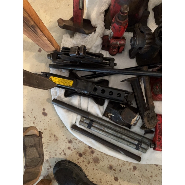Multiple car jacks including bottle jacks, scissor jacks, a mechanical ratchet jack, iron bars, and 