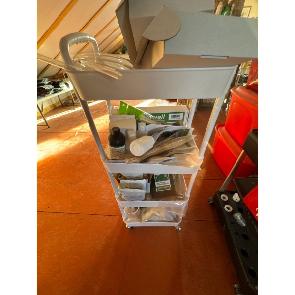 White metal cart with 4 shelves with all contents included, there is growing supplies and different 