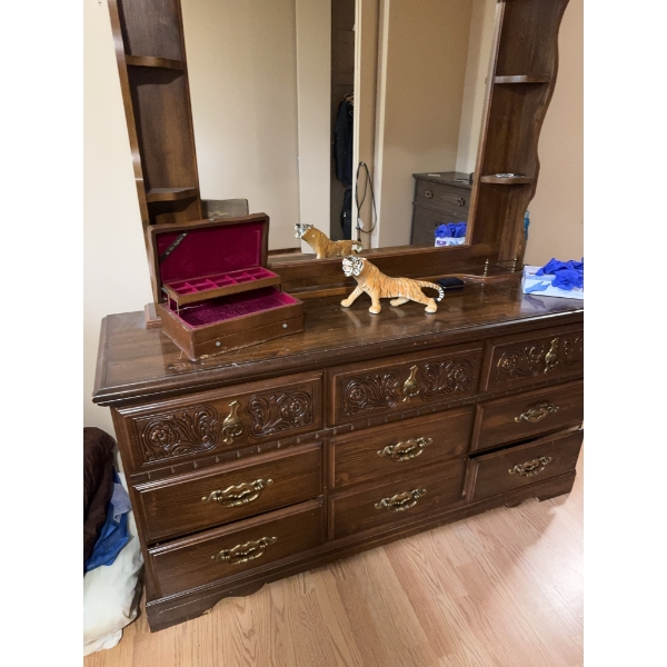 Wooden storage cabinet with double doors featuring interior shelving suitable for organizing CDs or 