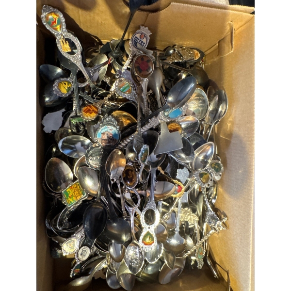 large collection of vintage souvenir spoons, likely made of silver-plated metal, stainless steel, or