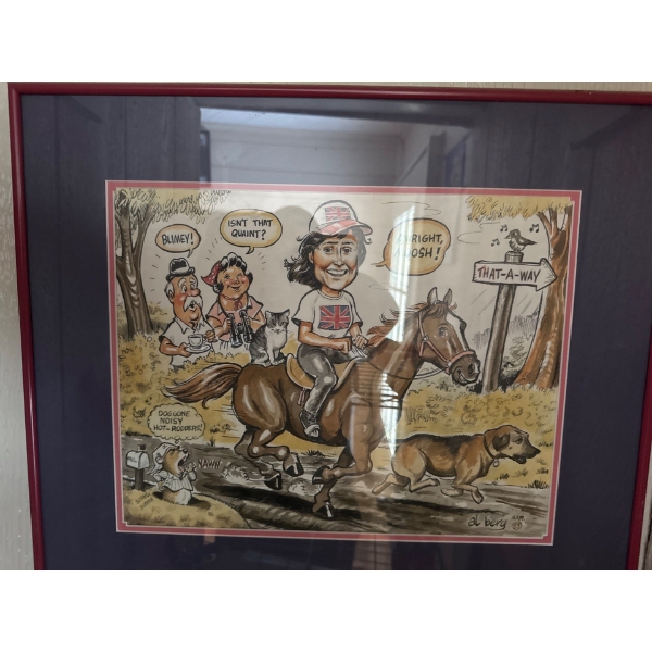 This framed image is a cartoon drawing by Al Berg featuring a woman riding a horse with a cat on its