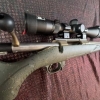 Image 4 : Ruger American bolt-action rifle chambered in 7mm-08 Rem. Features a green speckled synthetic stock,