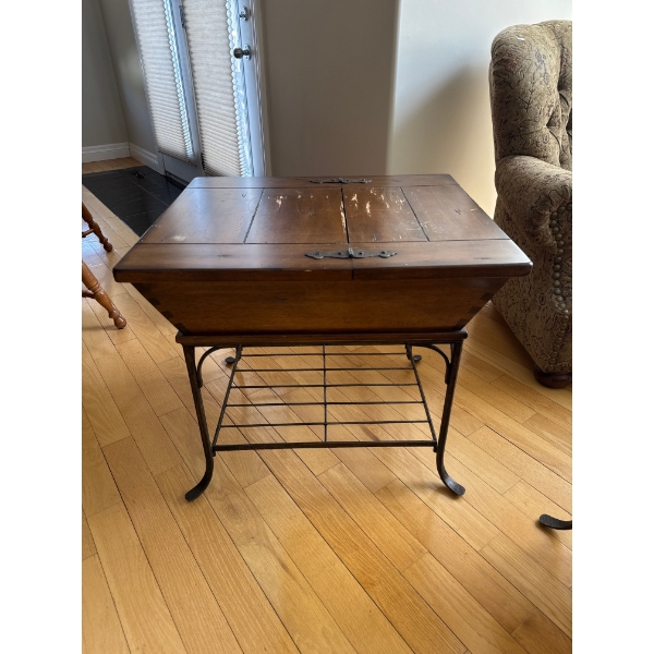 vintage side table featuring a traditional American dough box on a wrought iron stand.