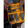 Image 6 : DeWalt screwdriver bit set in yellow case, a metal drill bit set in red case, a torque wrench, and v