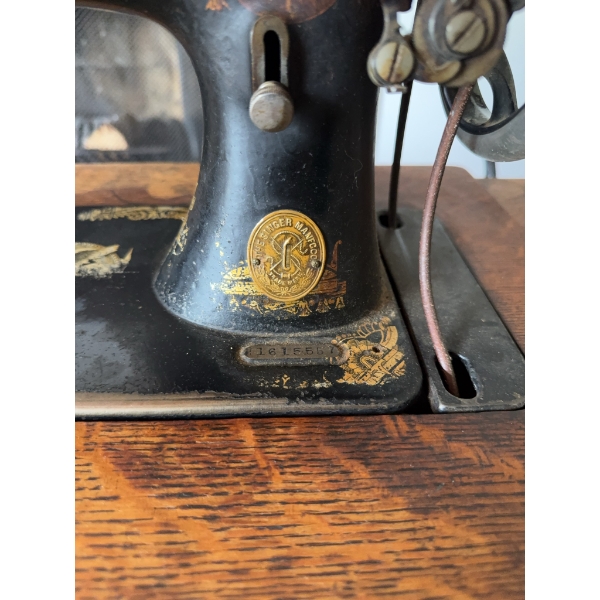 Singer treadle sewing machine, serial number 16165557, featuring original cast iron base and wooden 