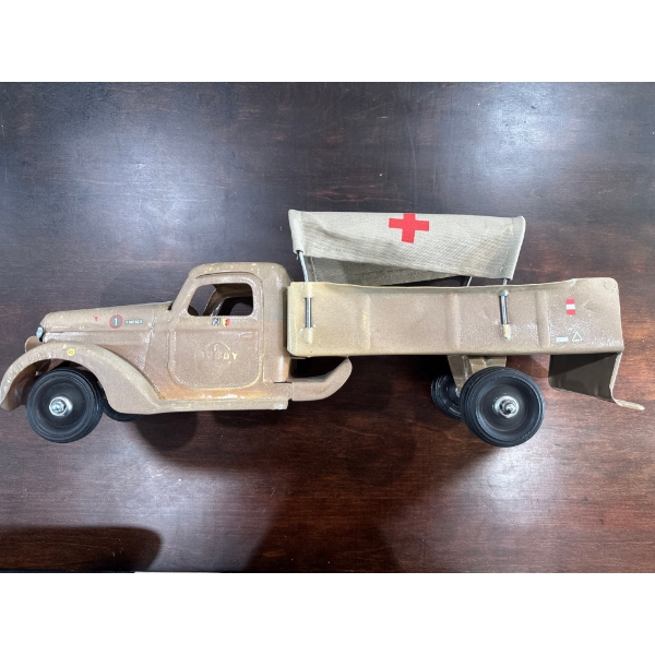vintage pressed steel or tinplate military ambulance toy truck, possibly inspired by designs from th