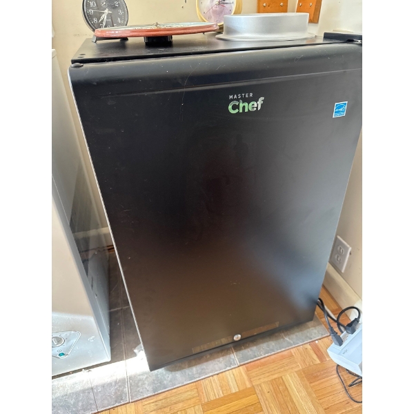 Master Chef Mini Fridge black with glass shelving. 17.5in wide, 32.5in tall and 18.5in deep, in work