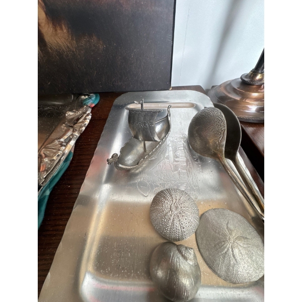pewter figurine of a Viking ship marked "NORGE" is a collectible souvenir, likely paired with other 