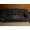 Image 6 : One blue fabric sofa with wood trim and one orange upholstered armchair with tufted back and wide ar