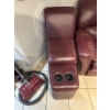 Image 2 : burgundy leather reclining sofa features a center console with built-in cup holders. 