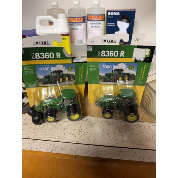 Two ERTL brand John Deere 8360R toy tractors, model year 2011. Both are new in original packaging an