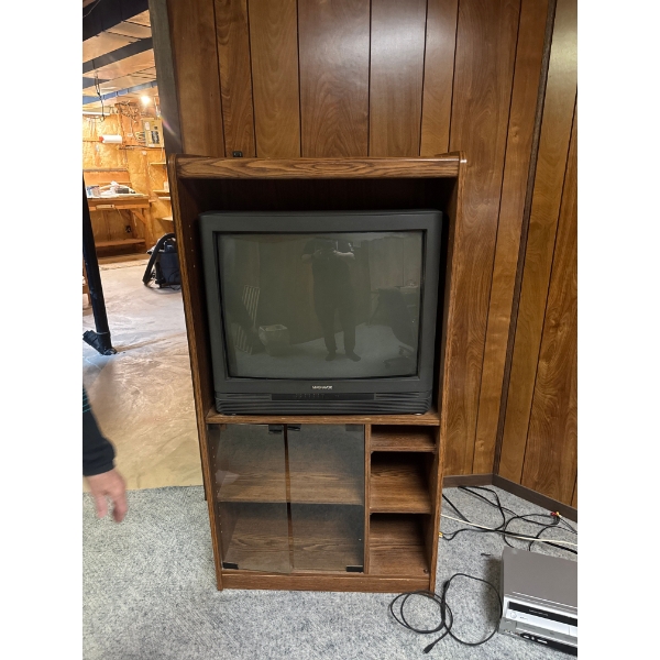 This vintage-style wooden entertainment center features a classic design for holding a cathode-ray t