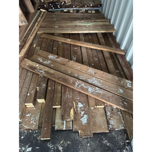 various lumber 2x2 2x4 2x6 full lengths in front of frames on floor