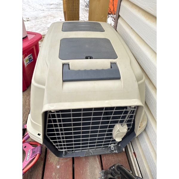Pet carrier with handle and lockable cage door, 17.5in wide, 20in tall and 30in deep. 