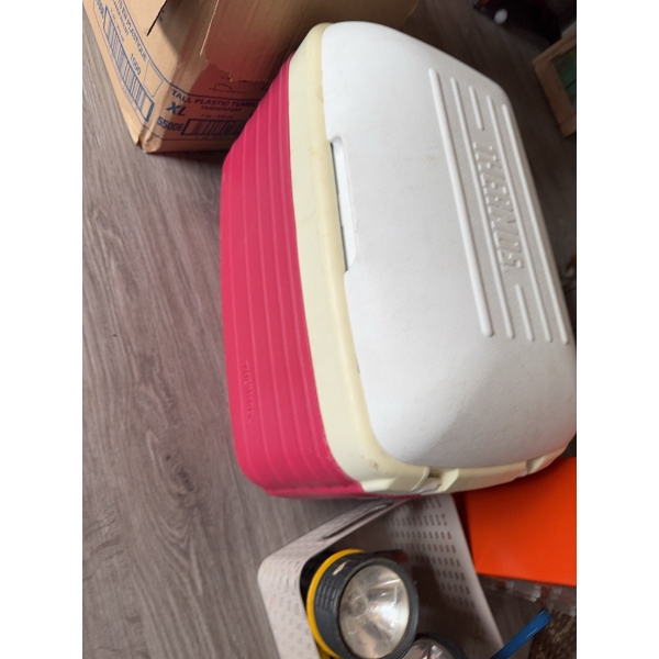 Orange plastic drawer organizer, a red and white cooler, two yellow handheld flashlights, a handheld