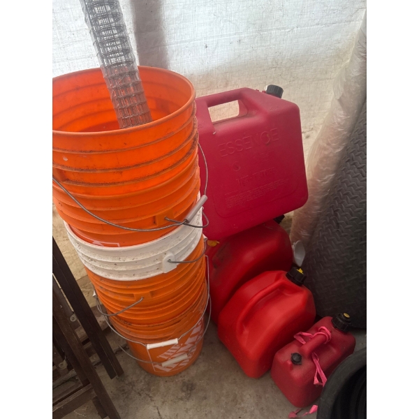 Seven 5 gallon pails and multiple jerry cans with a role of brand new wire mesh